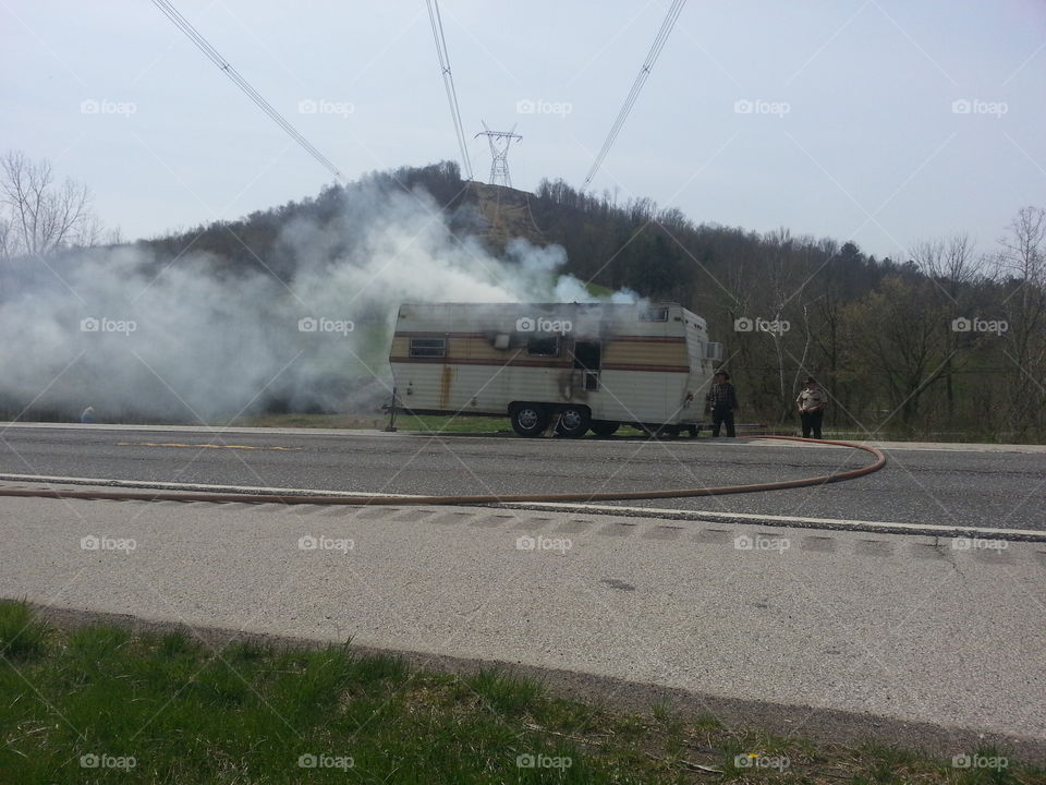 Camper fire. Camper on fire along the road