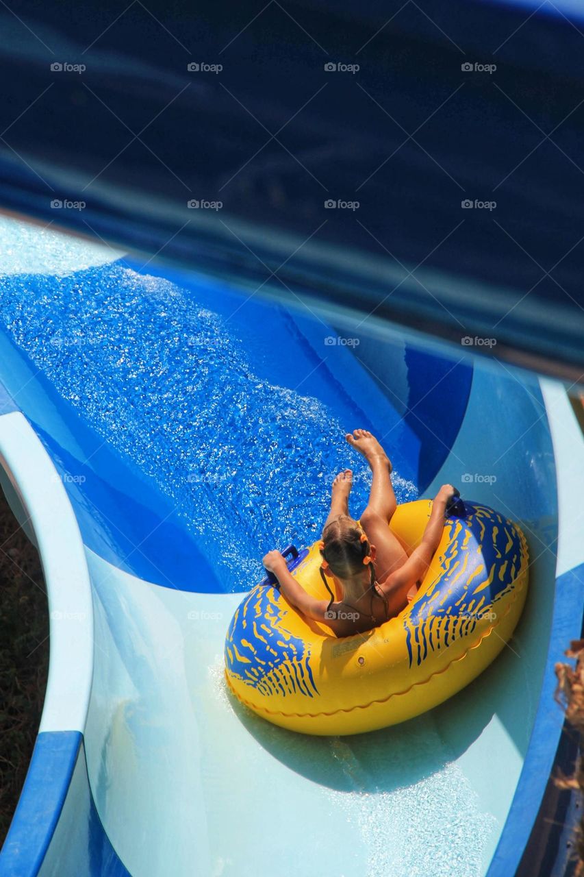 Girl in aquapark in rubber ring