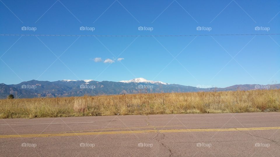 Texas Desert Mountain Range, Southwest Blue Sky and Clouds, yellow grasses.