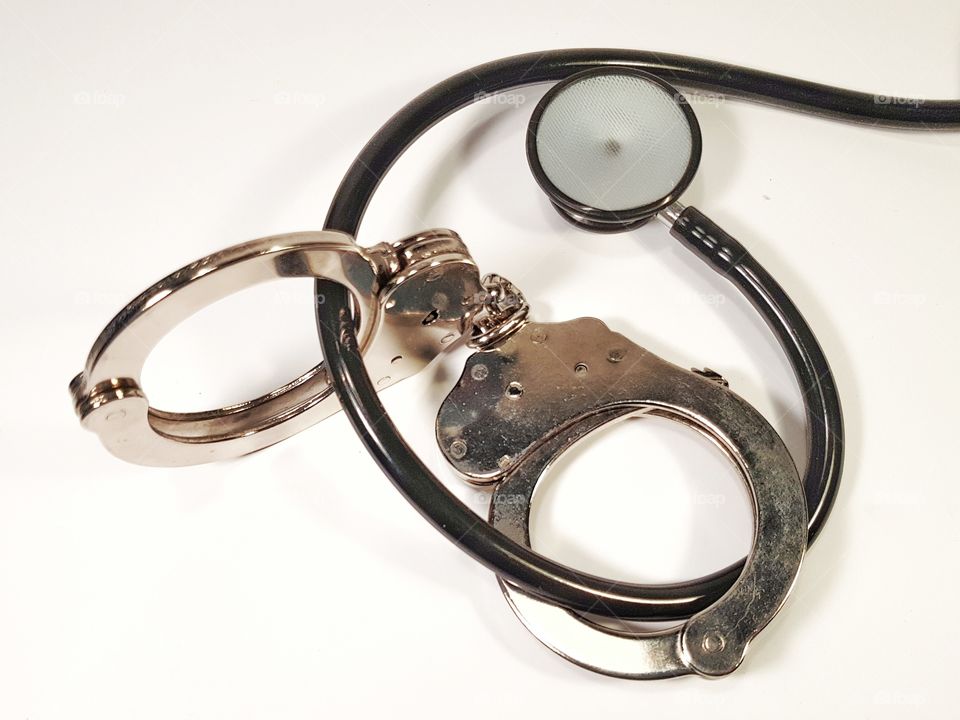 Handcuffs and stethoscope