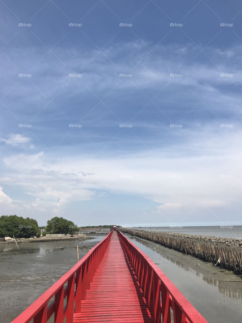Red bridge beside sea