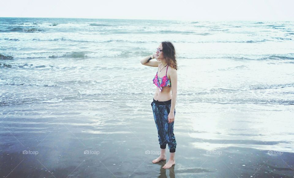Beautiful woman standing near the sea