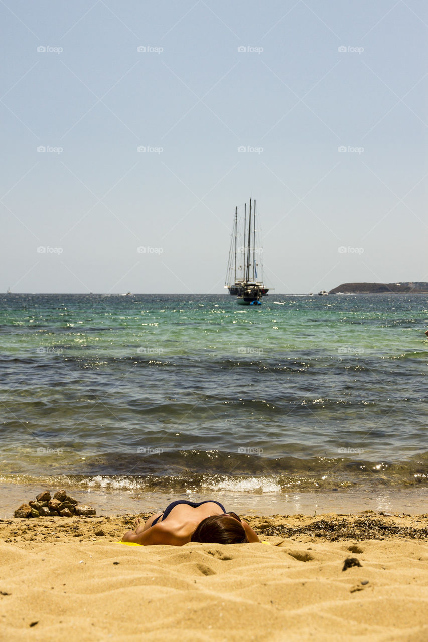 Man sunbathing on beach