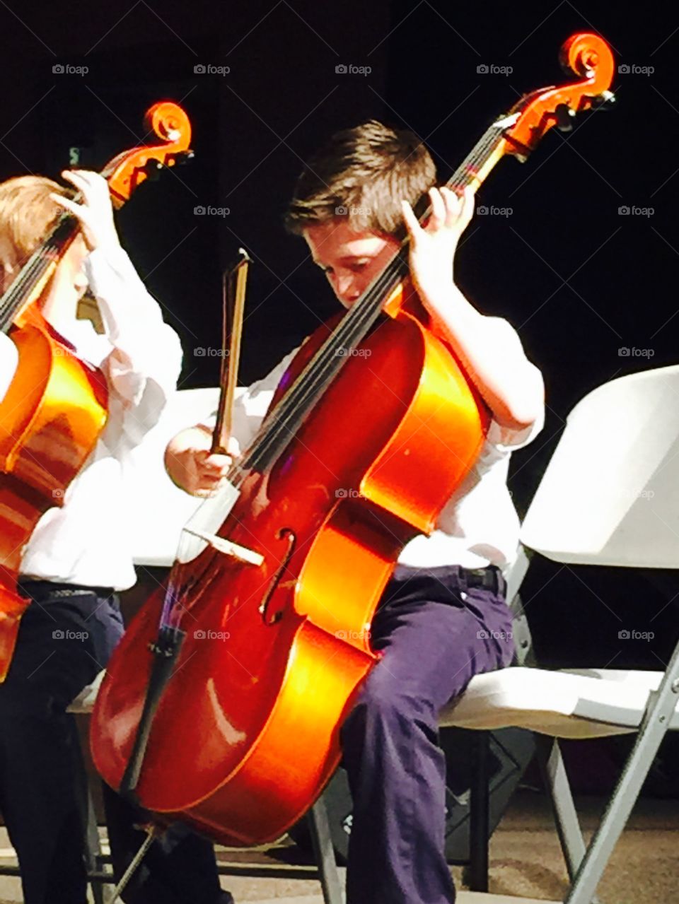 Cello. Boy playing cello at concert