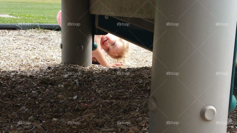 Girl peeking in playground