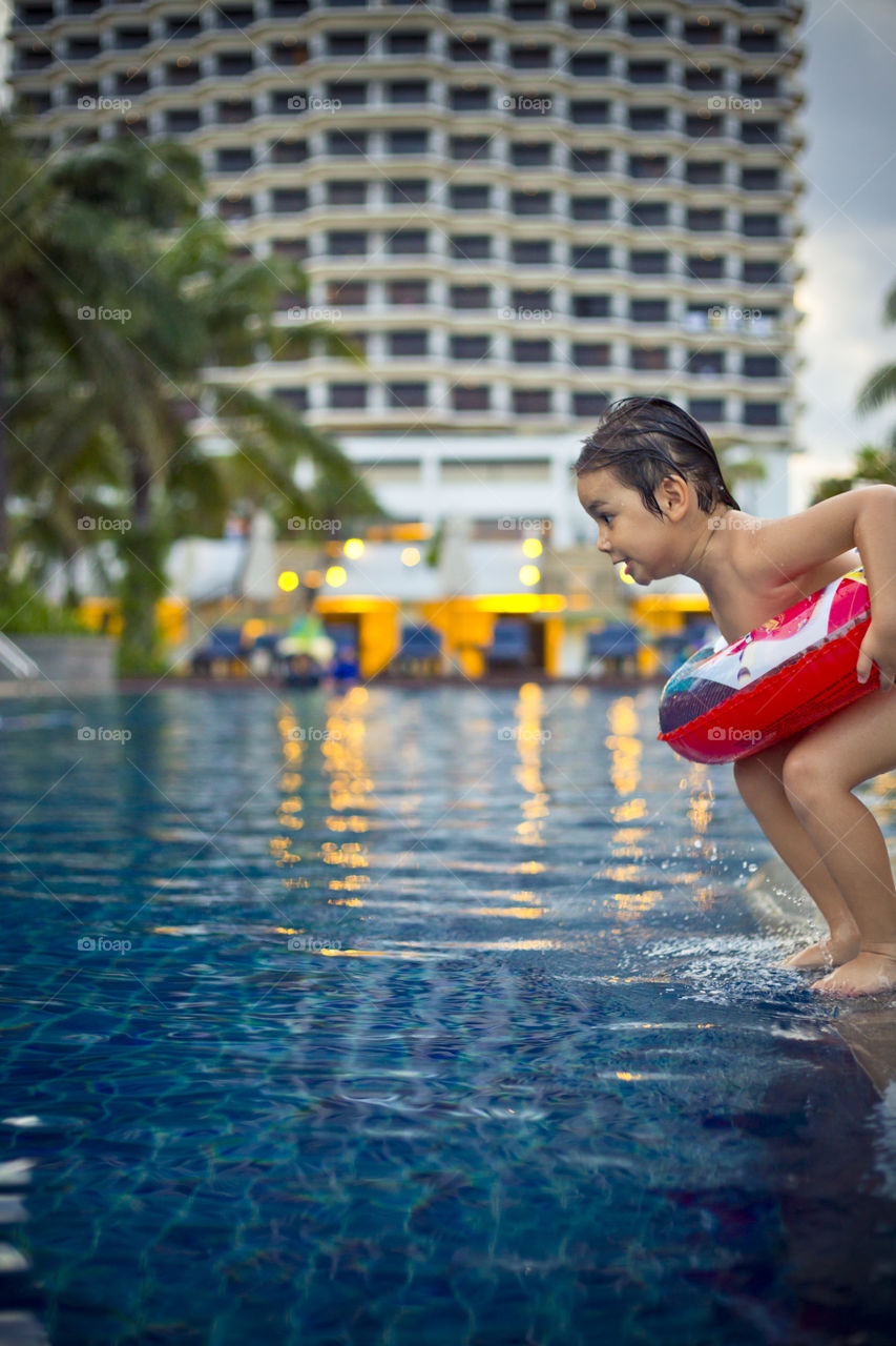 Young boy ready to jump into the pool. Thitiwin on holidays