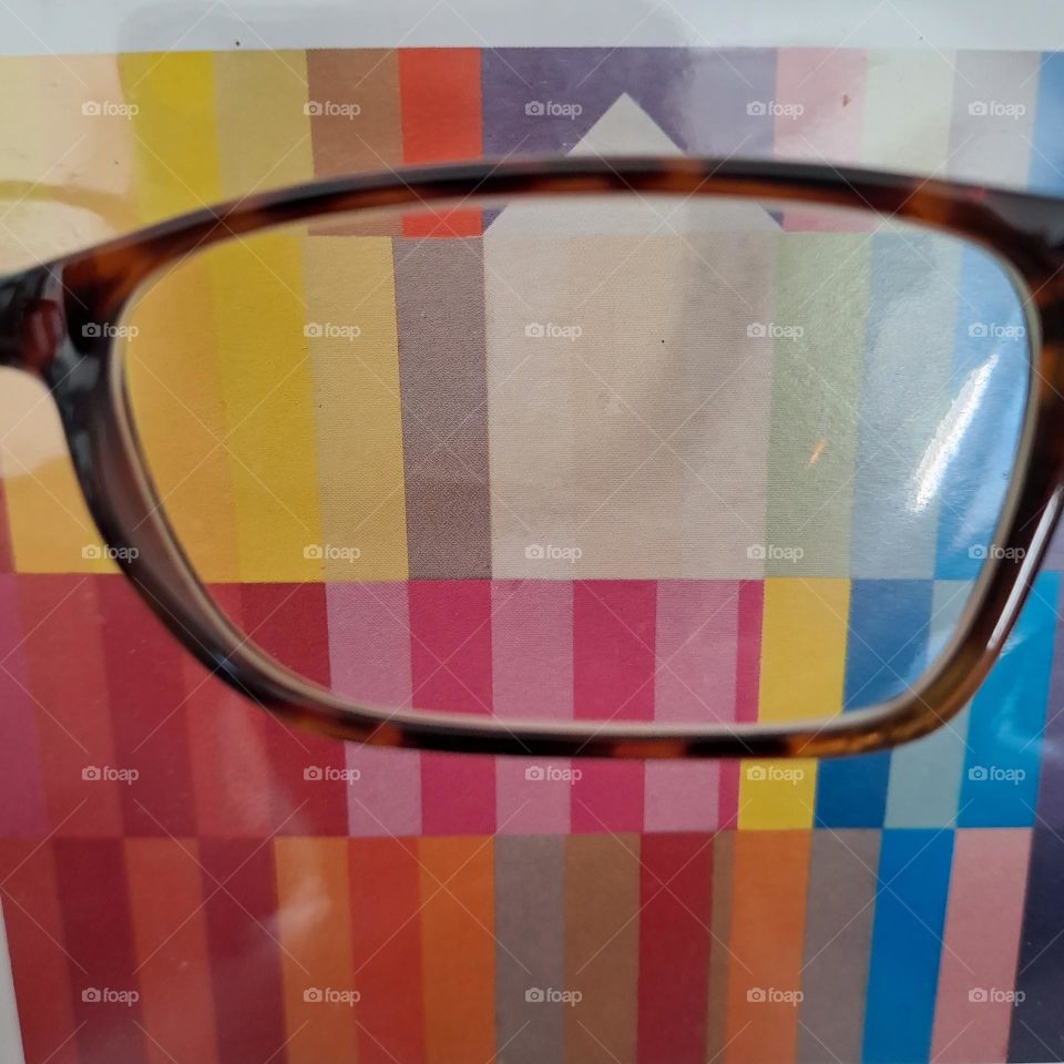 glasses lens looking at a bright picture close up colour stripes viewing art