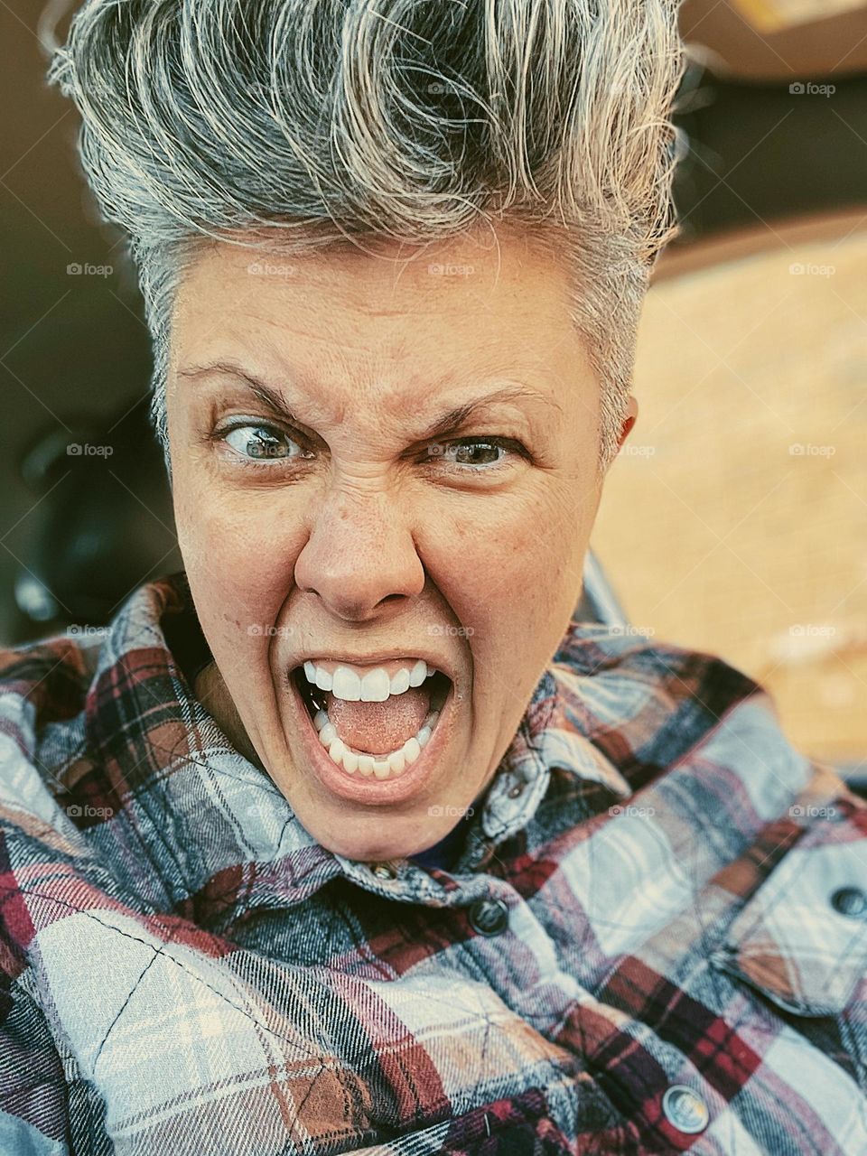Angry woman yelling down at you, woman showing the emotion of anger, woman gets angry while driving, angry woman screaming, angry facial expression on woman, the look of anger, angry while driving, angry road rage, angry woman in car