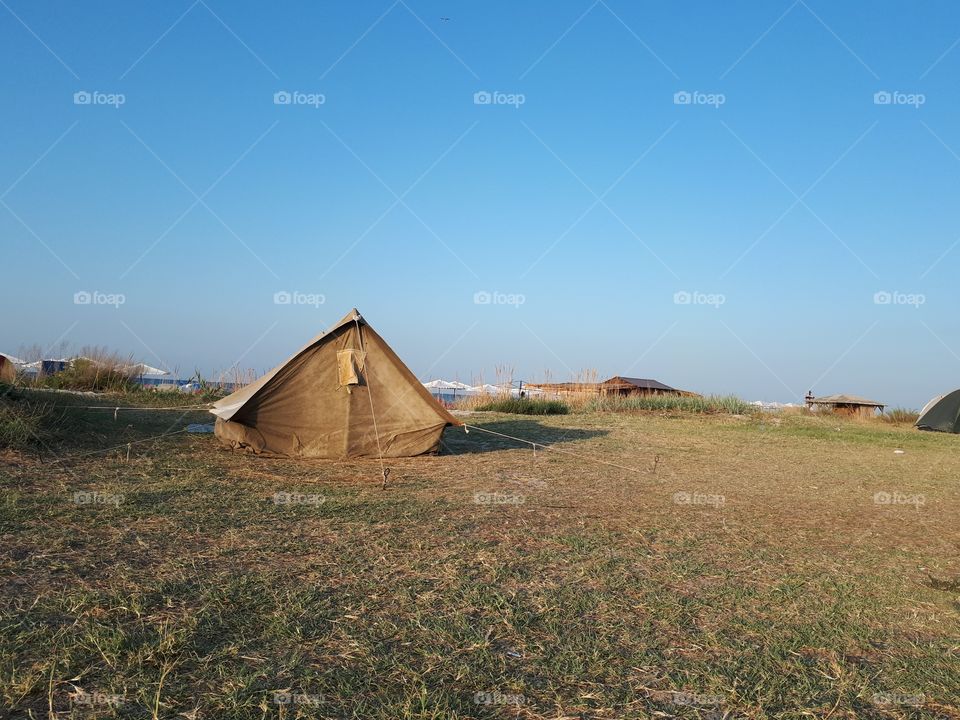 Old tent alone at the beach