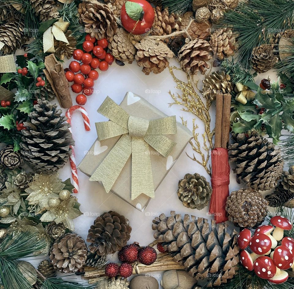 Festive flat lay of decorations centred around a wrapped present