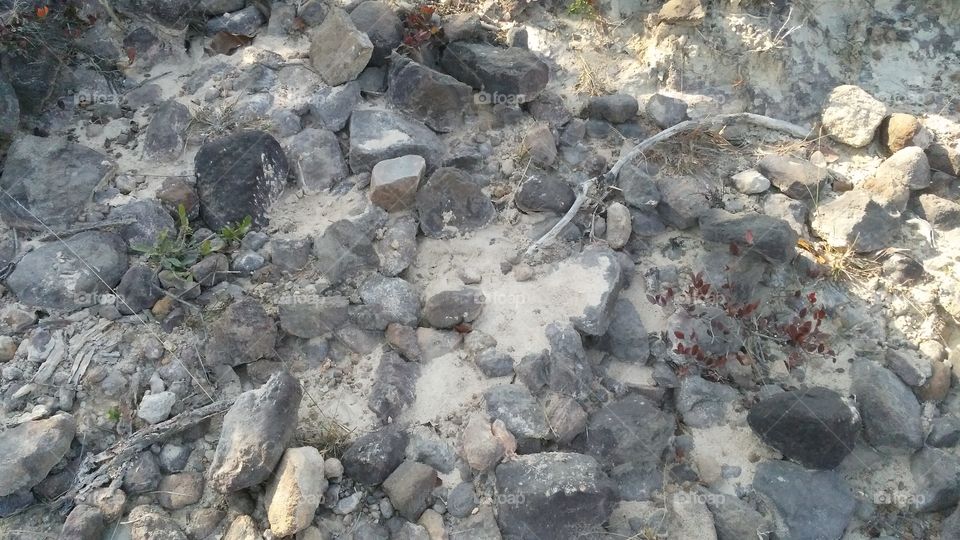 A beautiful scene of stones in the hills edge.