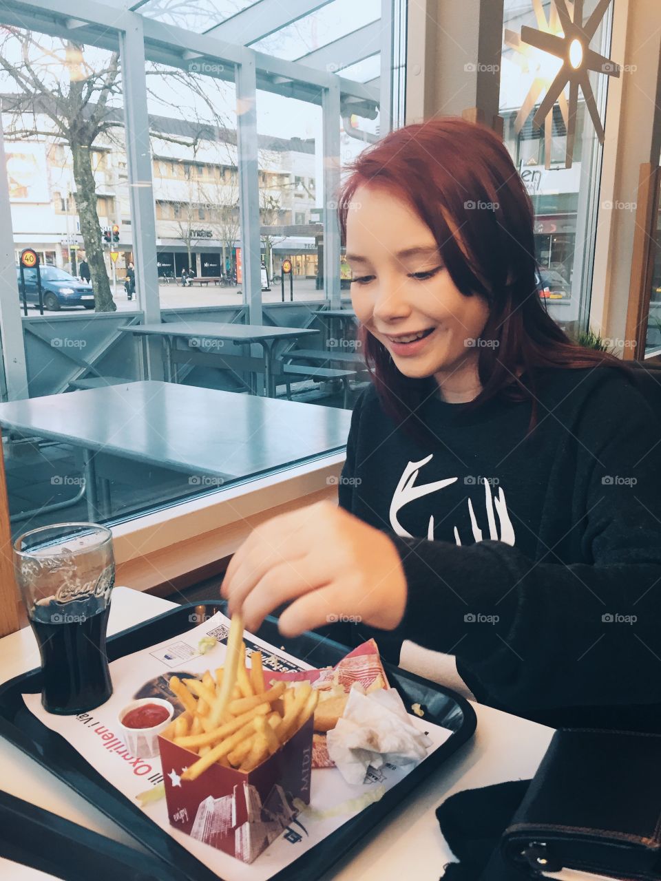 Happy girl eating pommes frites