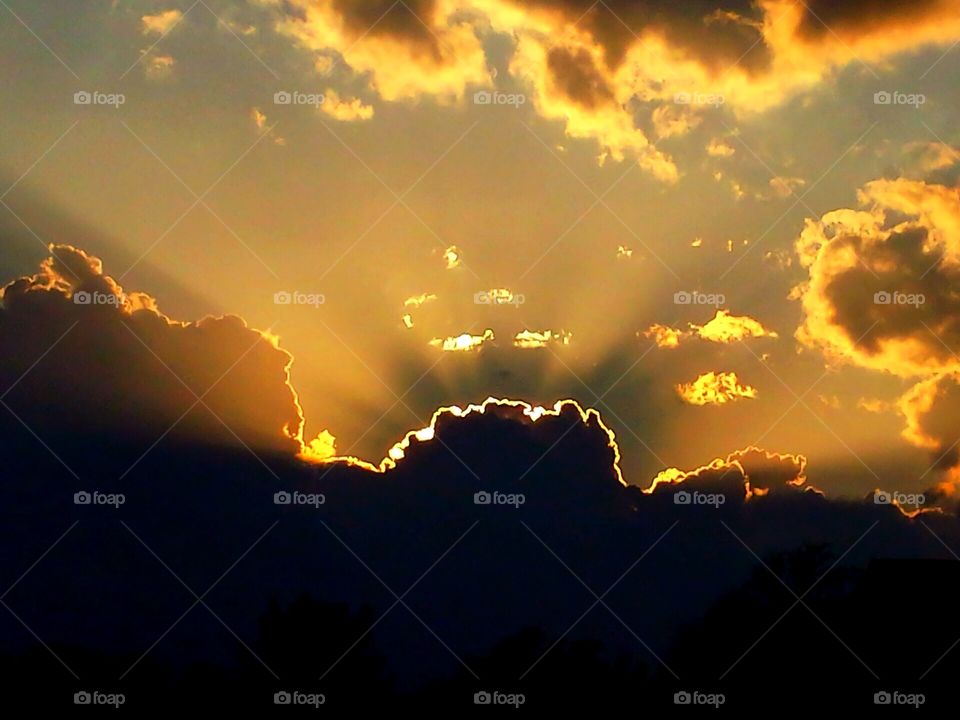 Sunset. From behind clouds