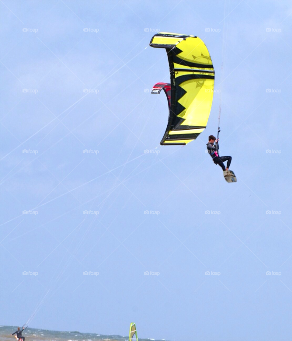 Kitesurfer jumping high in a stormy day