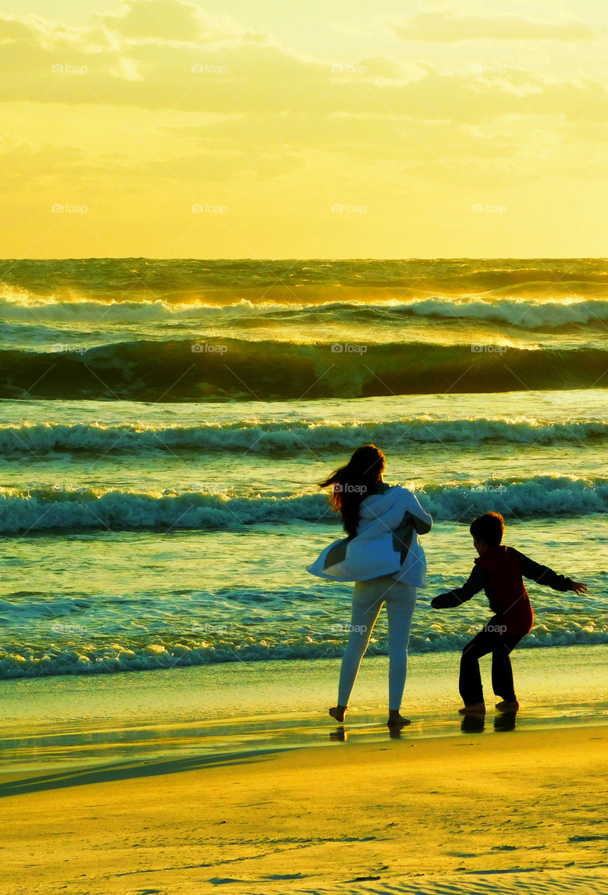 The giant waves crash the sandy beach as the sunset covers the Gulf Of Mexico!