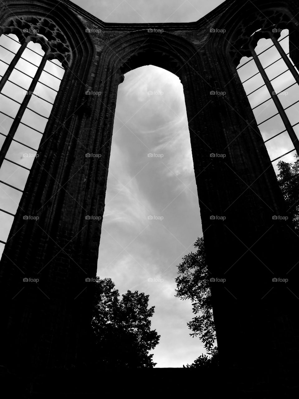 Low angle view of old walls and windows of a ruined abbey in Berlin, Germany.