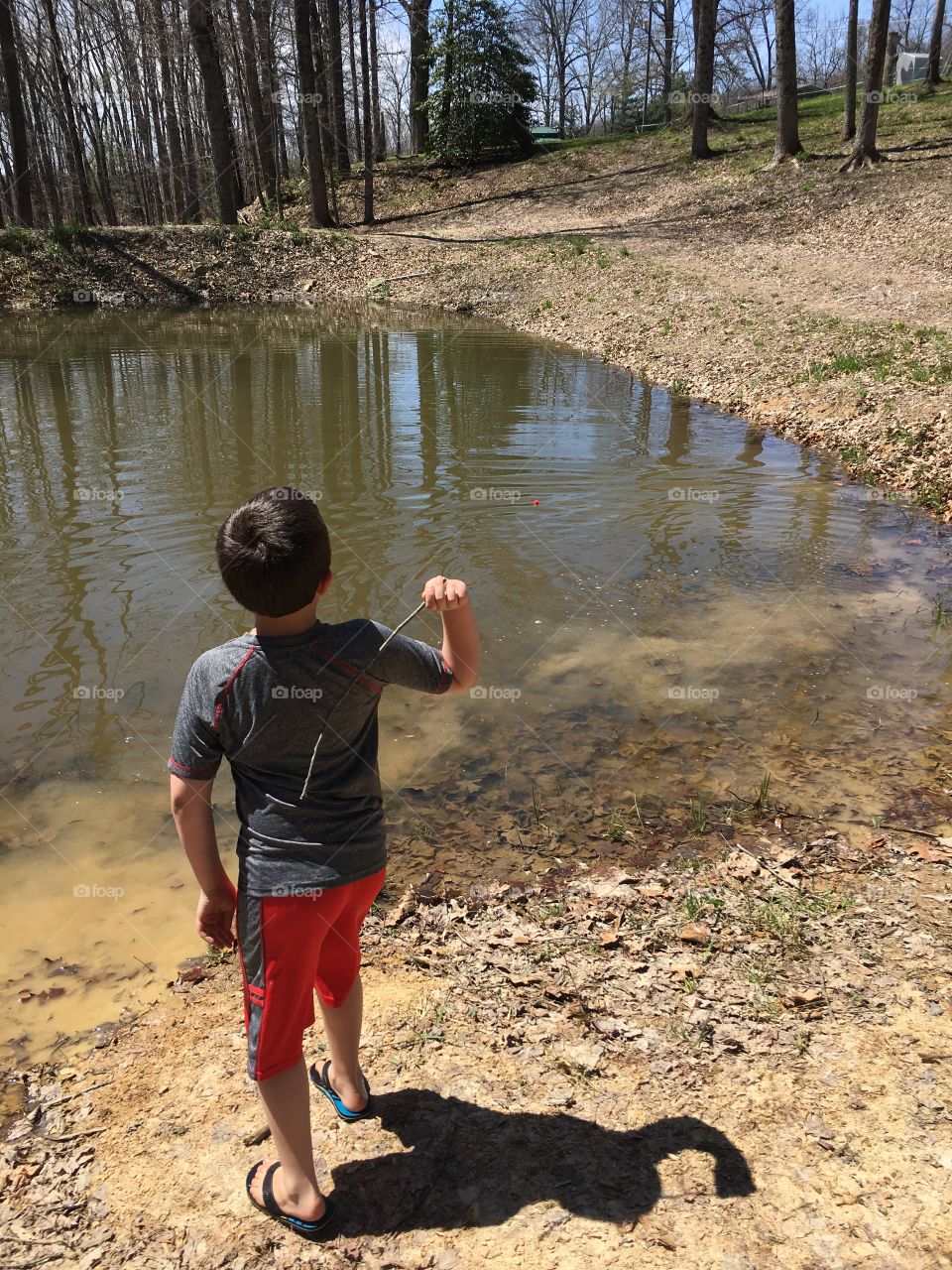 Throwing sticks in a pond 
