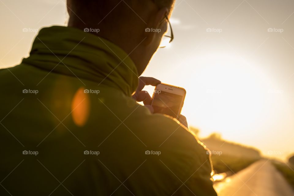 A man taking a picture of the stunning sunrise