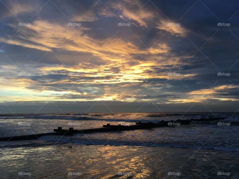 Ocean sunrise with a beautiful cloudy sky