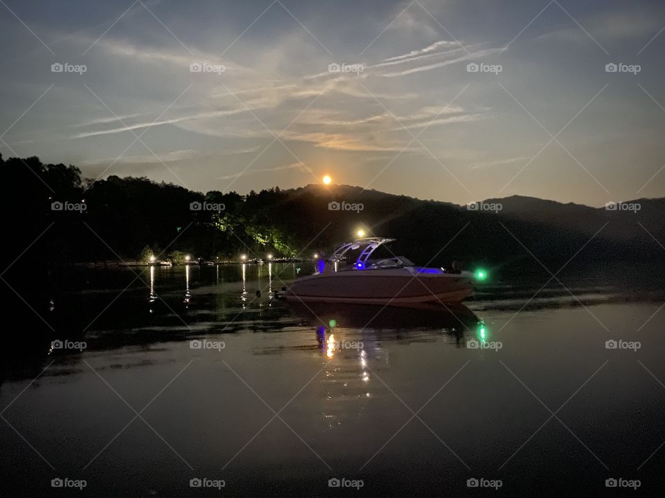 Beautiful night time boat ride with the moon peaking out over the low mountains of Kentucky 