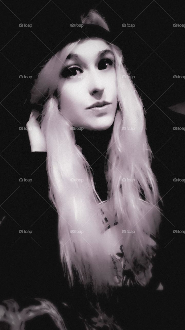 A black and white photo of myself with blonde hair and a black SnapBack 