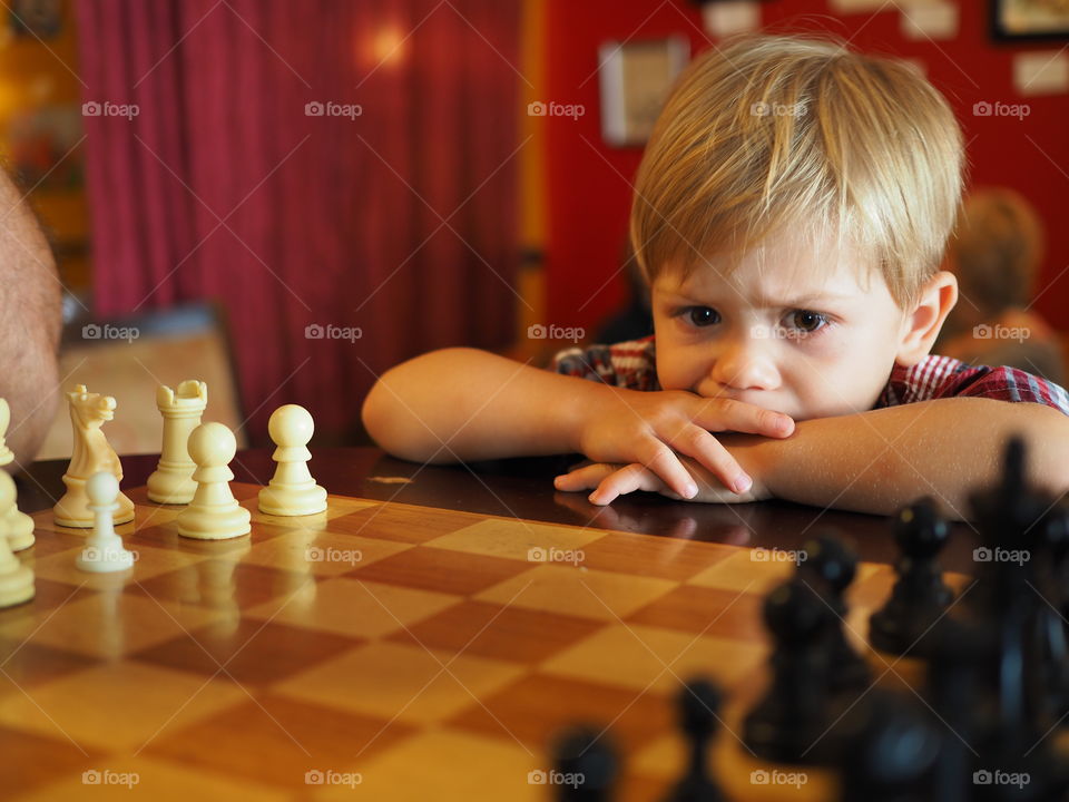 Close-up of a boy looking at chessboard