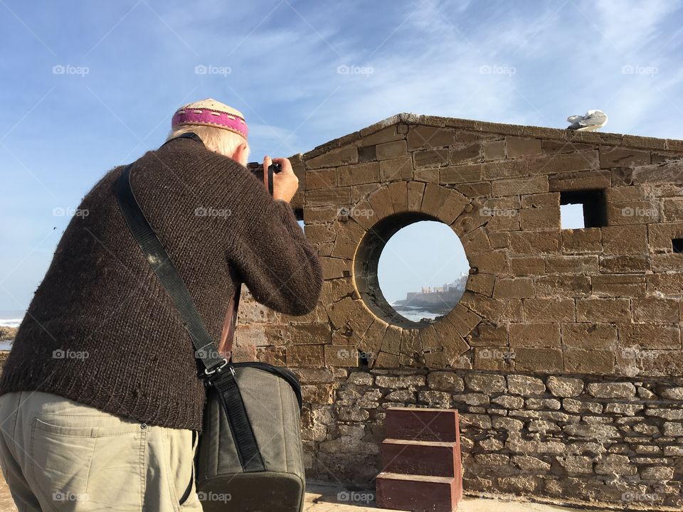 Man taking photo at fortress in Essouria 