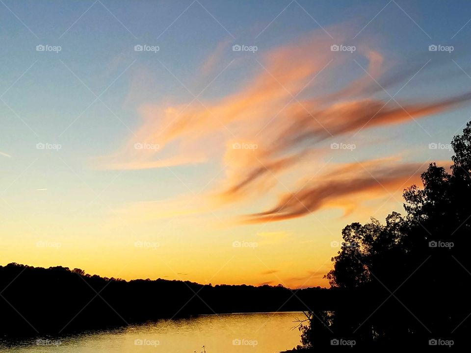 wispy clouds during sunset.