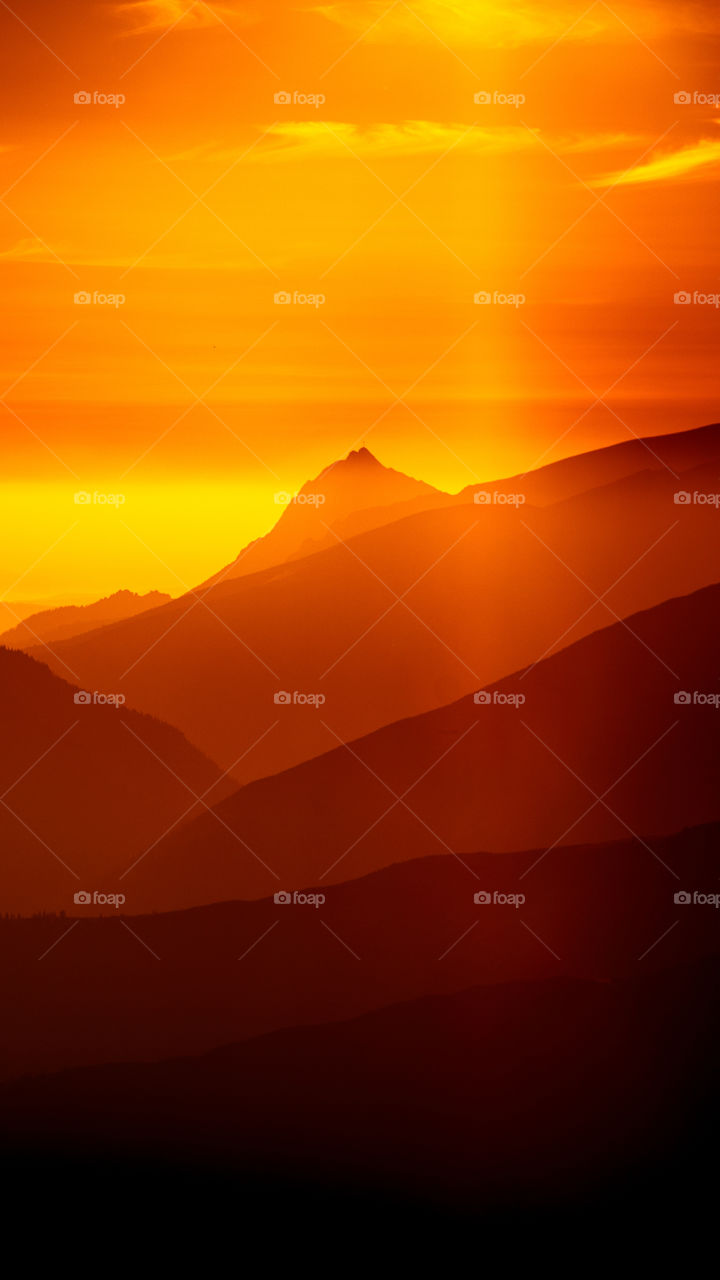 An inspiring red mountain landscape. Tatry mountains in Slovakia. A beautiful wallpaper for smartphone screen. Red abstract gradient with perspective.