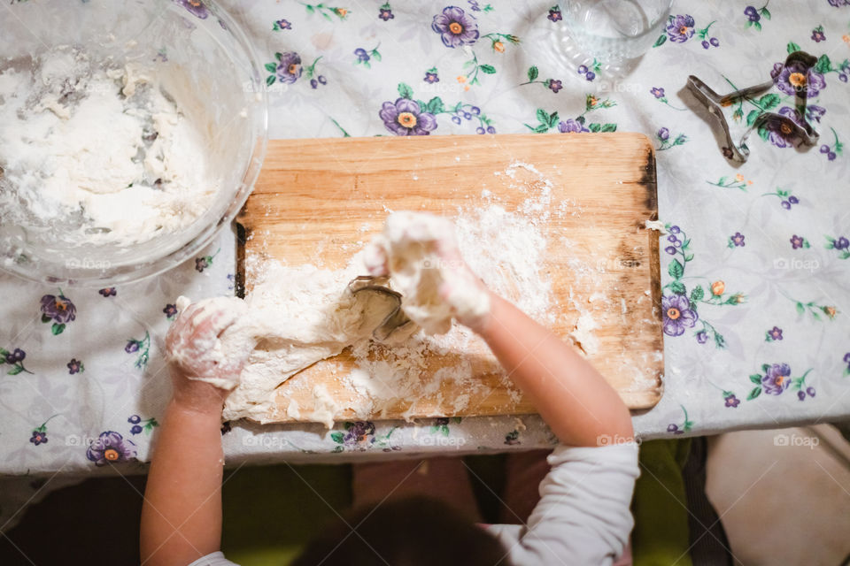 Child while playing with pasta and flour during the quarantine from Covid-19