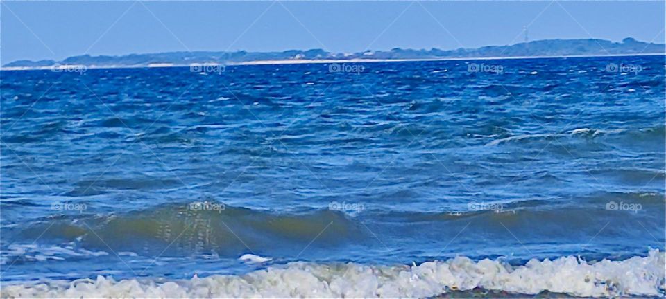 This is the roaring “Baltic Sea” or “Ostsee” rushing up onto the beach of the island “Hiddensee” in “Mecklenburg - Western Pomerania”, Germany making whitecap waves as it approaches the shore. 2024. Hypnotic Productions