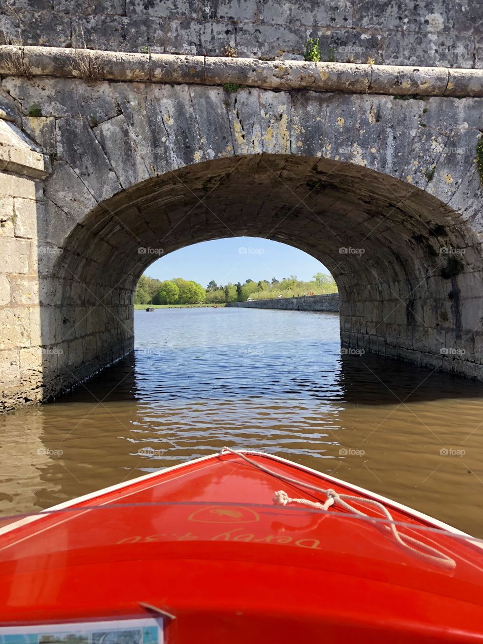 A boat ride around the river surrounding Chateau Chambord in France! Going under a bridge. 