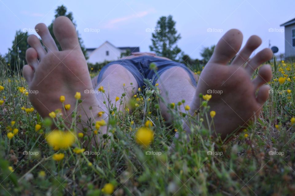 Man Resting Bare Feet in the Grass