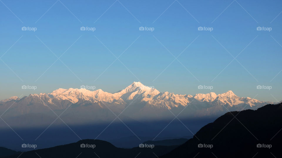 Snow capped mountains at sunset