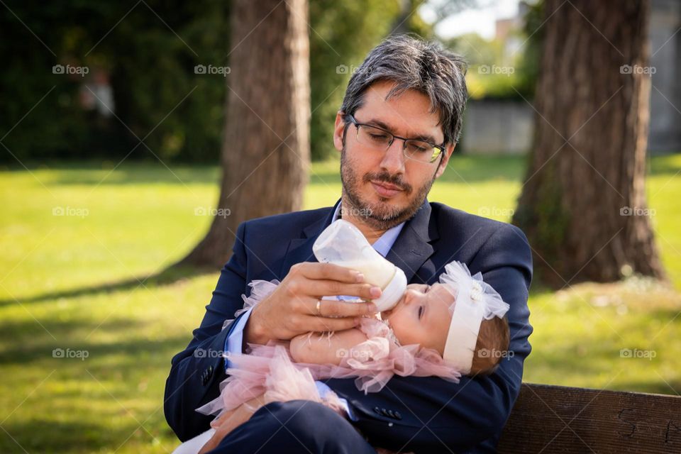 Father and little daughter. The father feeds the child.