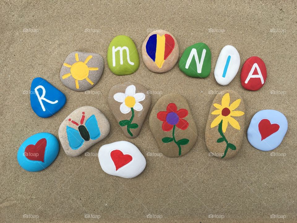 Romania on colored stones with sand background 