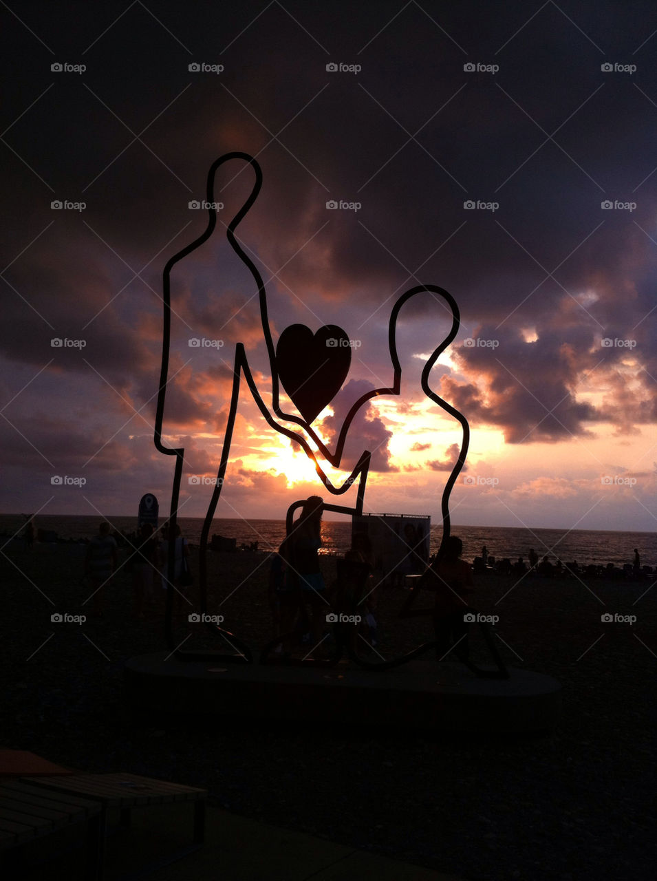 Heart shape structure on beach at sunset