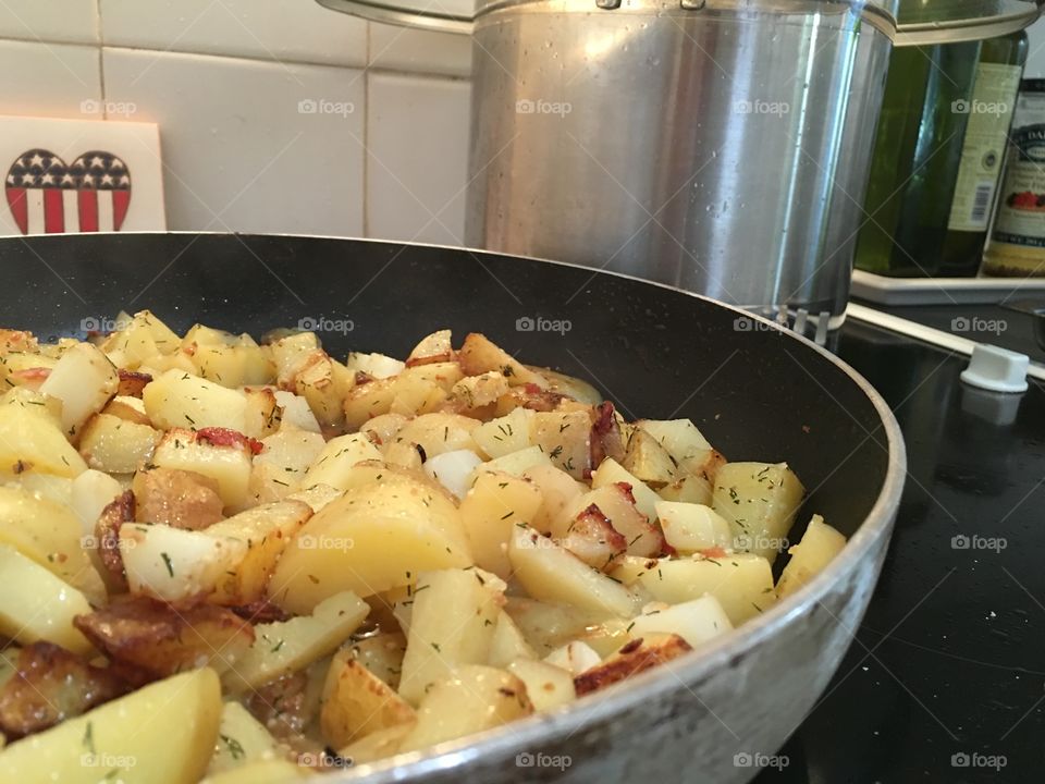 Diced seasoned new potatoes in frying pan