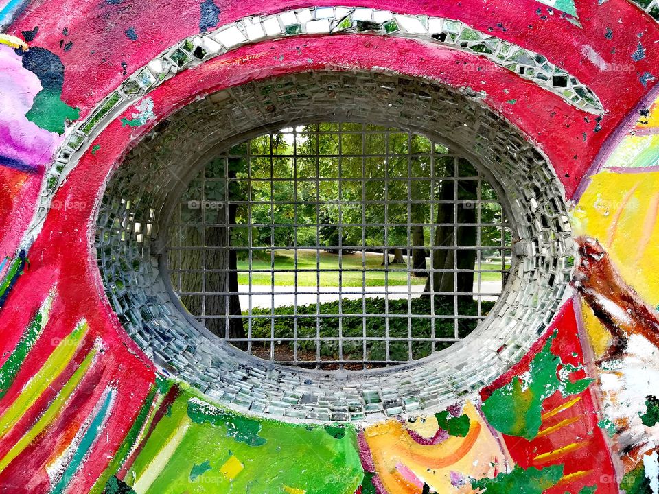 A wall in the park with a window