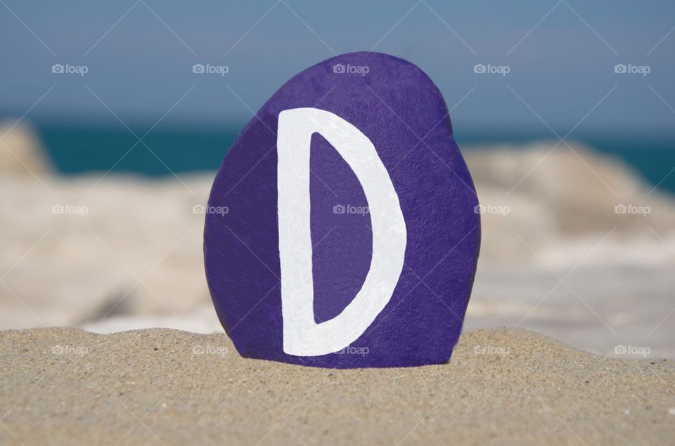 D,fourth letter of the alphabet on a stone