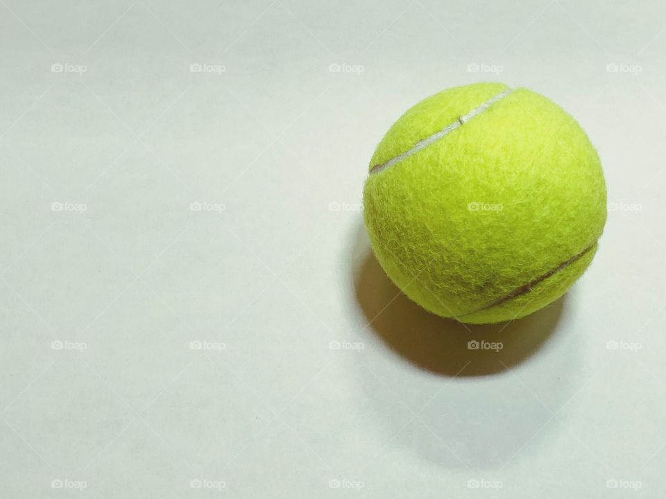 Tennis ball lay flat in white board