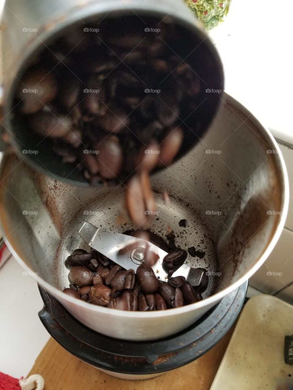 Coffee Beans Falling into a Grinder