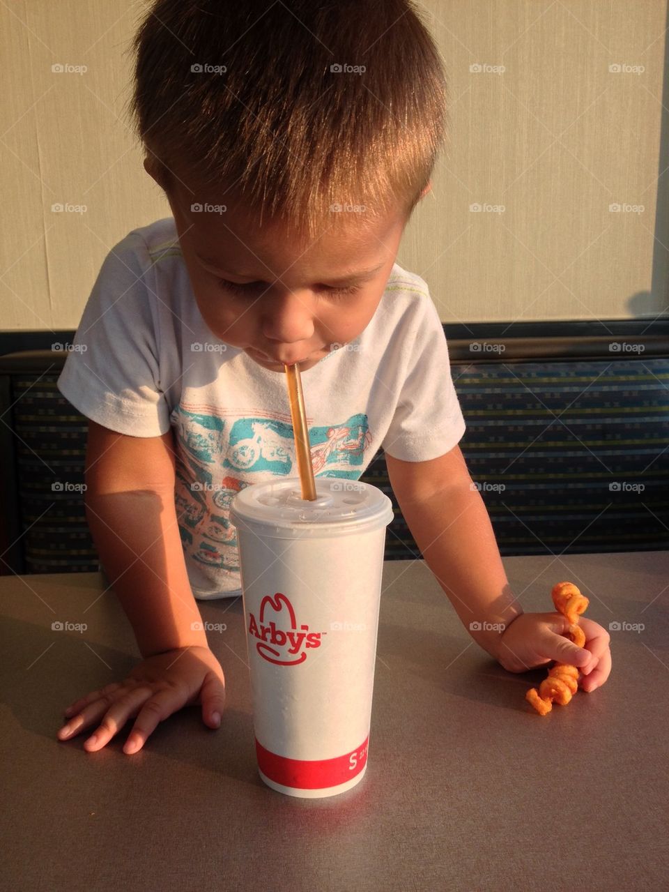 Child enjoying his drink in Arby's 
