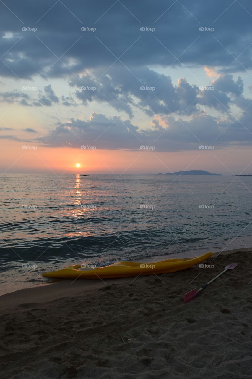 Kayak on the beach during sunset
