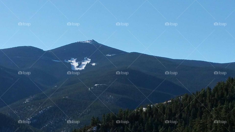 Some snow on the side of the mountain.