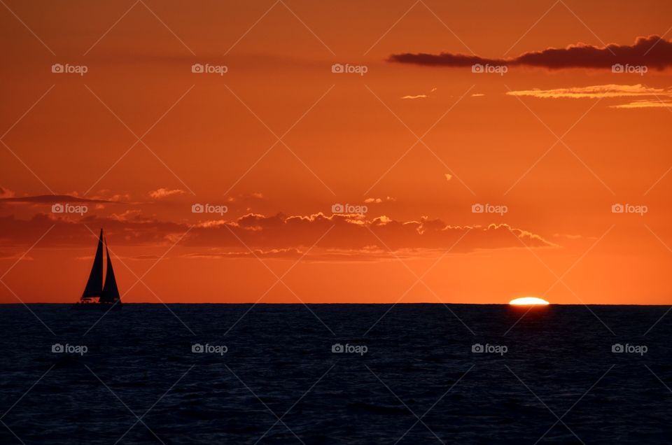 Some moments are just perfect and this sunset with the sailboat silhouette and the sun sinking below the horizon is one of them