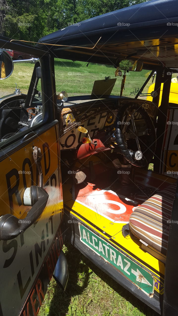 This car , my favorite,  was titled a Half Rat for the rat rods. Notice the street signs are used as panels . A screwdriver is used as a column shift and and an old phone handset is used as door handle and armrest and an old  rusty wrench