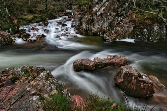 View of stream flowing through rocks