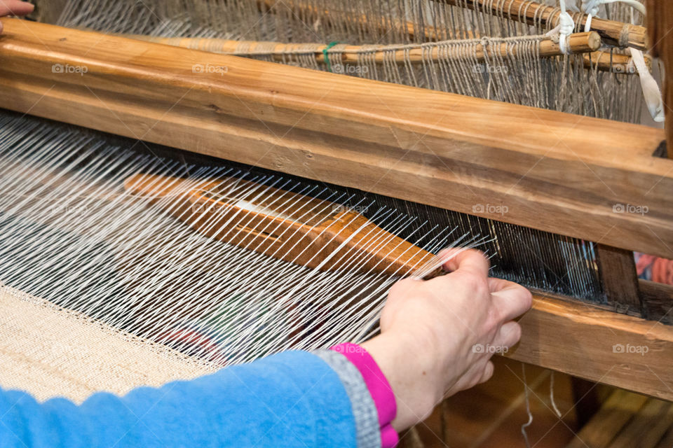 Woman working on loom