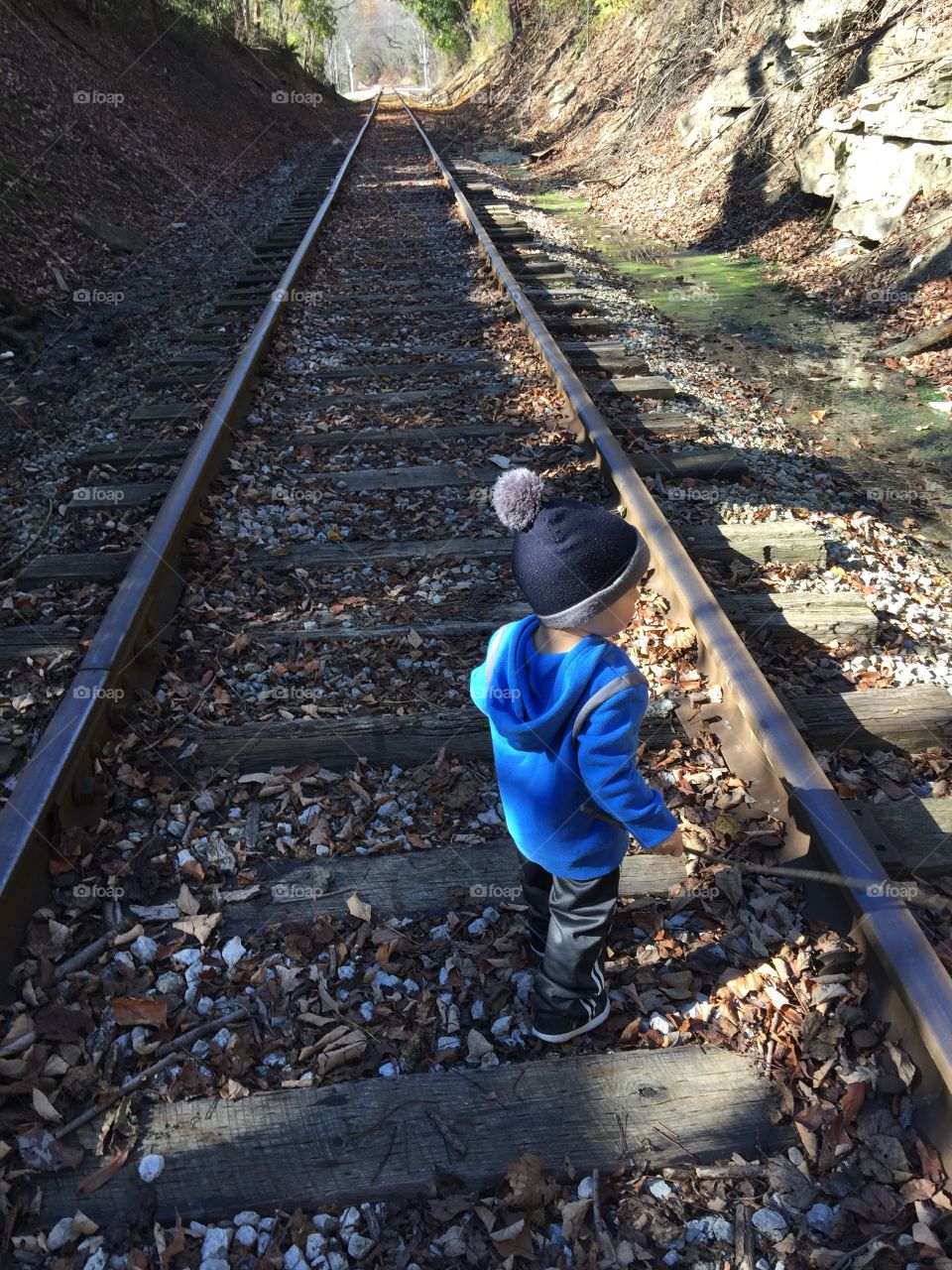 Boys, trains, sticks, and rocks
